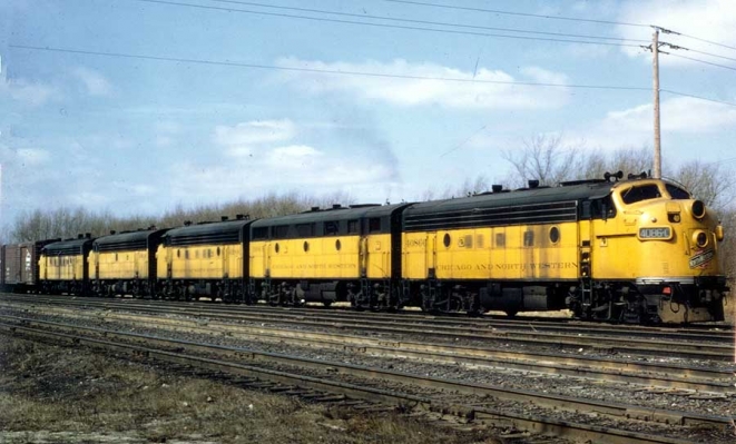 F7  4086C  St. Francis, WI
Five F units, borrowed from commuter service on the weekend, are pulling through track 3 in St. Francis Yard.  St Francis Yard is west of the tower toward Mitchell Yard.  Ronald A. Plazotta photo, 3-1970.  
Submitted by J. H. Yanke.
Keywords: F7  4086C  St. Francis, WI