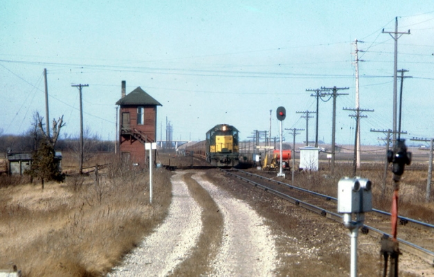 Tower  Waxdale, WI
An eastbound ore train is crossing the Milwaukee Road main at Waxdale on the New Line sub.  The tower, formerly named "Willow" is now out of service as Waxdale is an automatic interlocking.  Photo taken by Bob Ferge in March 1968. Collection of J. D. Ingles, submitted by J. H. Yanke.
Keywords: Waxdale New Line