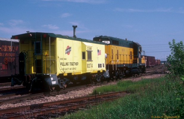 Caboose  CNW  10374  Butler, WI
C&NW Way Car #10374 in the "Safety yellow" paint scheme joined GP7 4131 on an early Sunday morning Caboose Hop through Butler Yard on 6/19/1983... Photo by John F. Campbell...
Keywords: Way Car Waycar Caboose Butler Hop