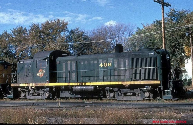 RS3  406  Belle Plaine, IA
Former Litchfield and Madison RS3 #406 at Belle Plaine, IA during October, 1967.  This unit (formerly L&M 301, later CNW 905) was one of two Alco RS types to be painted into the experimental all-green scheme.  (The other Alco road switcher was RSD5 #1690).  The 406 was destroyed in a collision with a Milwaukee Road freight at Elberon, IA on March 24, 1968 while still in its solid green paint.  Mike Guss collection
Keywords: RS3 L&M 406